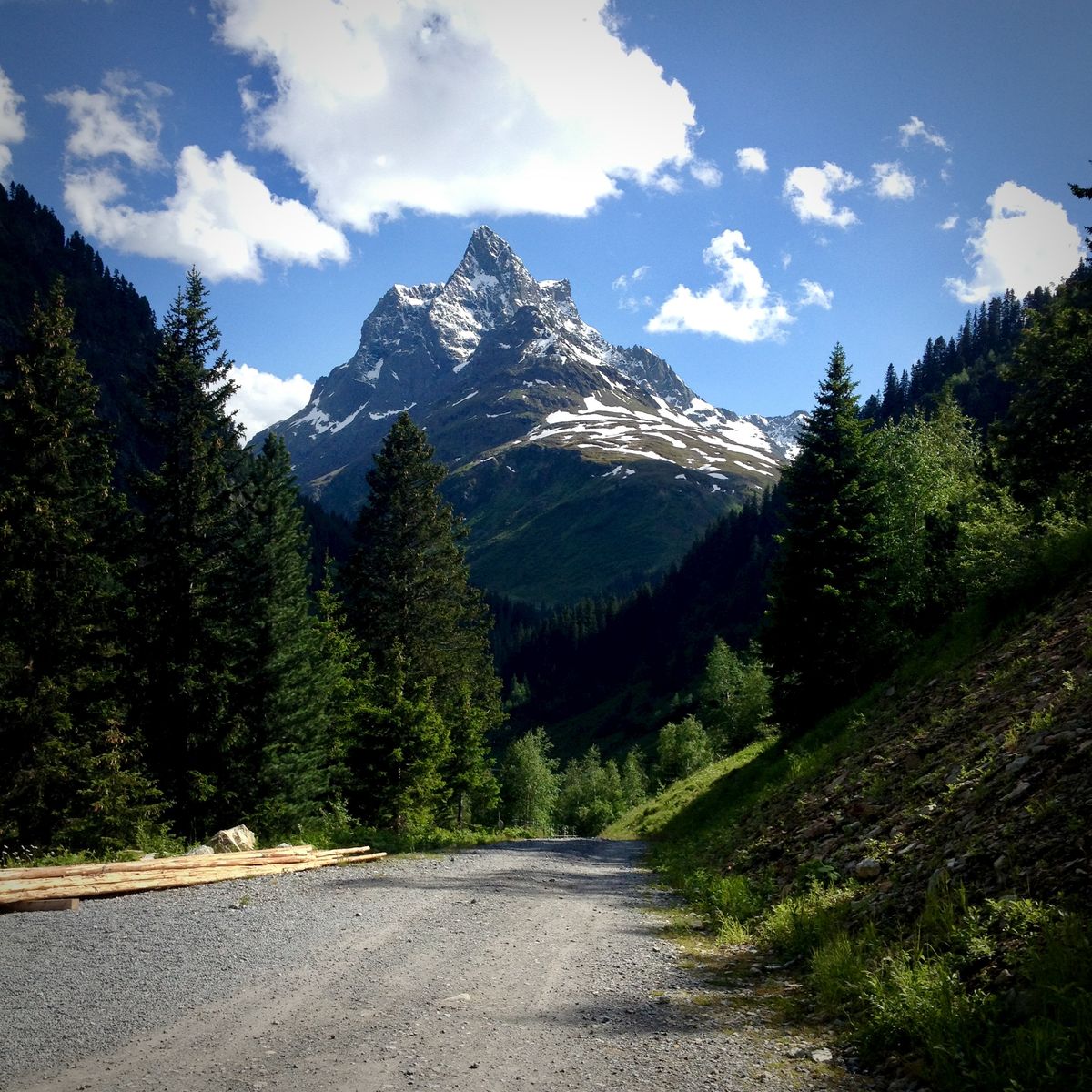 Alpine cycling road with mountain peak